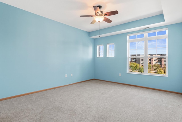 empty room featuring ceiling fan and carpet floors