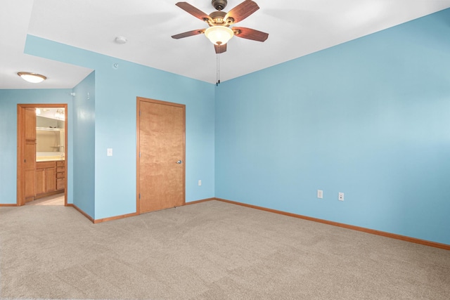 unfurnished bedroom with connected bathroom, ceiling fan, a closet, and light carpet