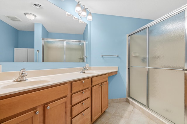 bathroom featuring vanity and an enclosed shower