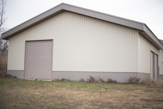 view of side of home featuring an outbuilding and a garage