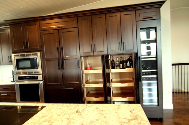 kitchen featuring light stone countertops, appliances with stainless steel finishes, wooden ceiling, and lofted ceiling