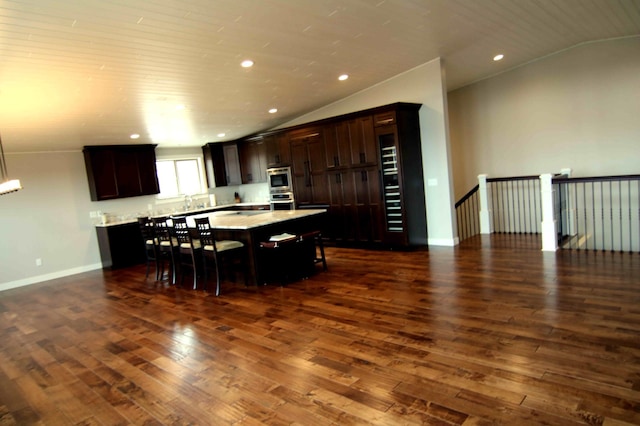 dining room featuring dark hardwood / wood-style floors and lofted ceiling