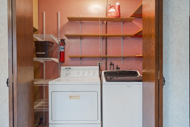 washroom with washing machine and clothes dryer