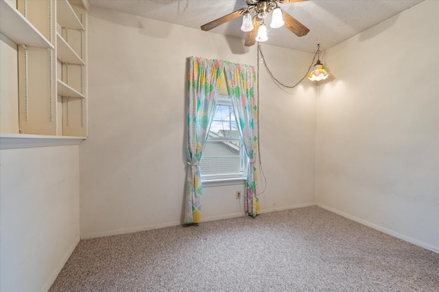 spare room featuring carpet flooring and ceiling fan