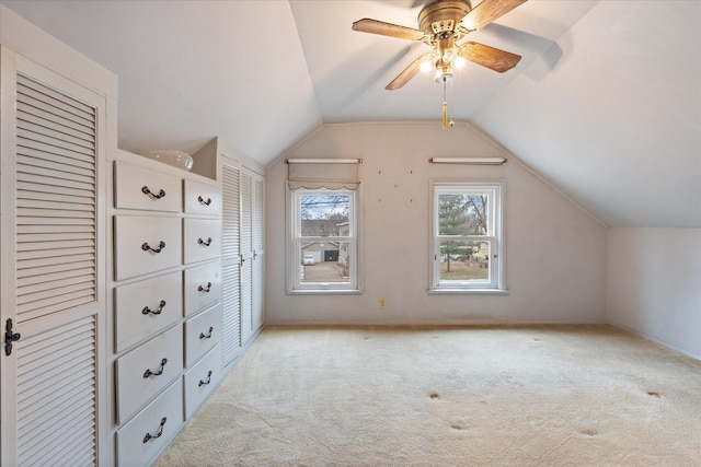 bonus room featuring lofted ceiling, light colored carpet, and ceiling fan