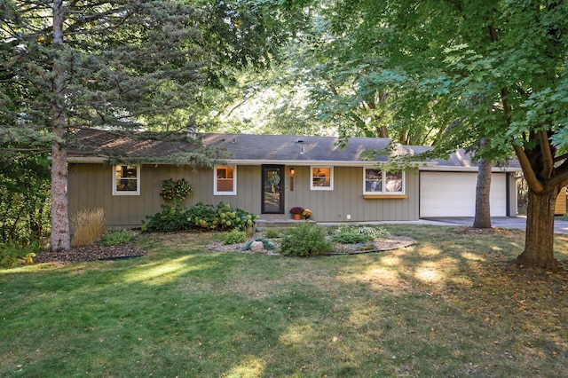 ranch-style house featuring an attached garage, a front lawn, and concrete driveway