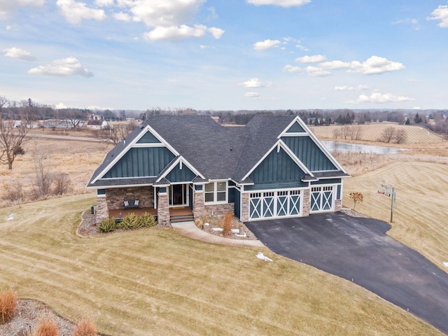 view of front of property with an outbuilding, a front lawn, and a rural view