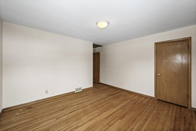 unfurnished room featuring wood-type flooring