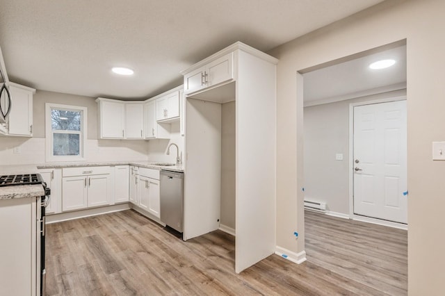 kitchen featuring dishwasher, white stove, sink, light hardwood / wood-style flooring, and white cabinetry