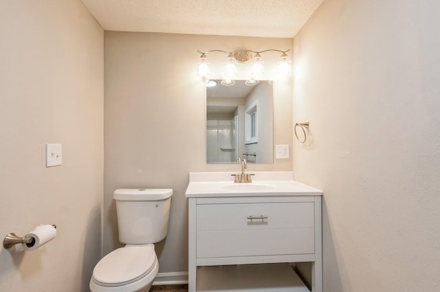 bathroom featuring vanity, a textured ceiling, and toilet