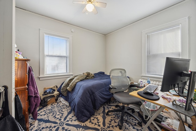 bedroom with ceiling fan and crown molding