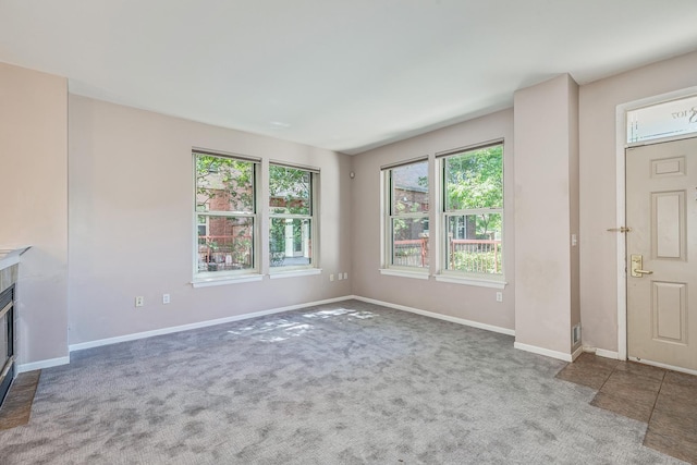 unfurnished living room featuring carpet floors