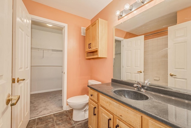 bathroom featuring tile patterned flooring, vanity, and toilet