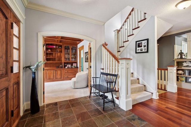 entrance foyer with plenty of natural light, ornamental molding, and a textured ceiling