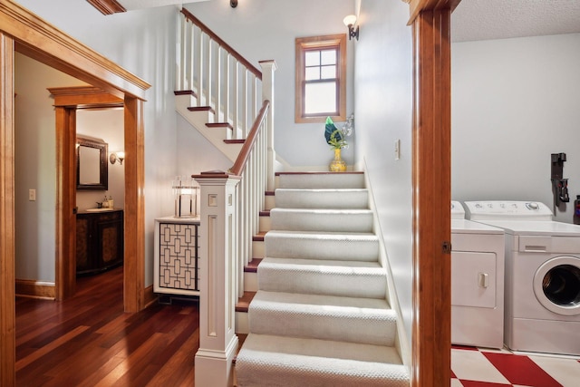 stairway featuring washer and dryer, hardwood / wood-style floors, and a textured ceiling