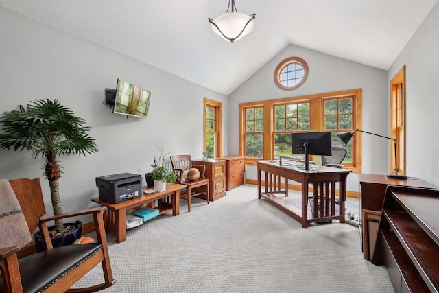 carpeted home office featuring vaulted ceiling