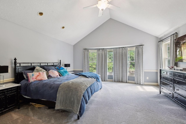 bedroom with multiple windows, carpet flooring, ceiling fan, and lofted ceiling