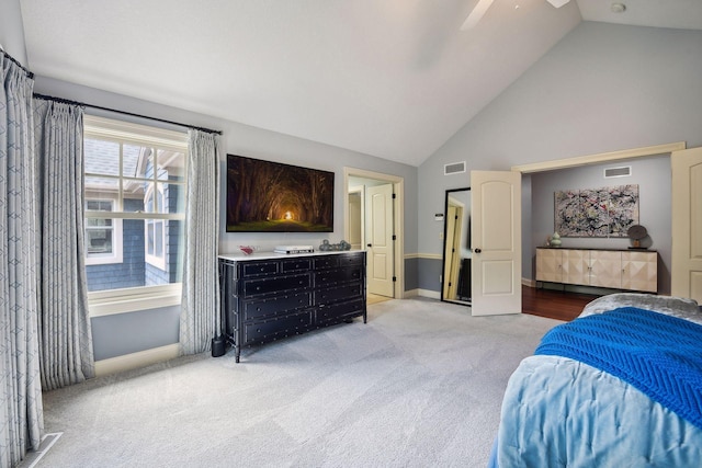 carpeted bedroom featuring ceiling fan and high vaulted ceiling