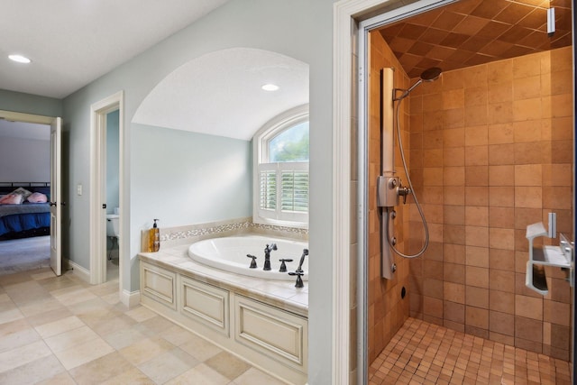 bathroom with tile patterned flooring and independent shower and bath