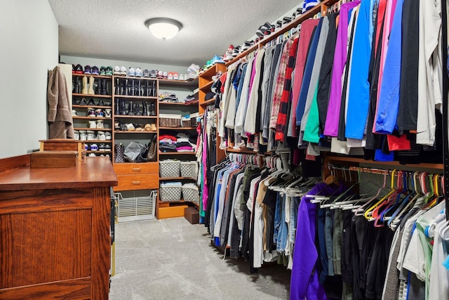 walk in closet with carpet floors