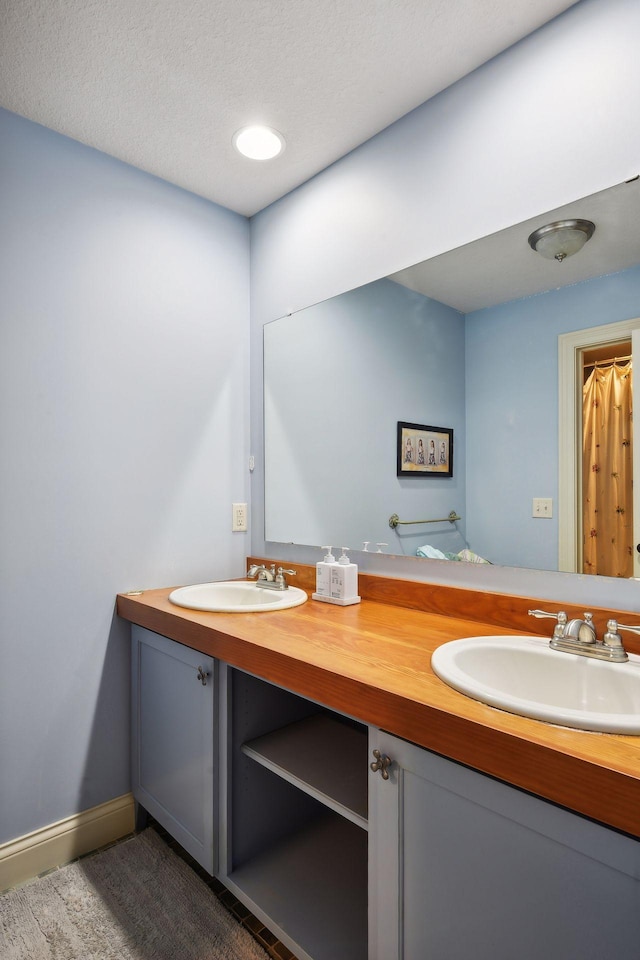 bathroom with a textured ceiling and vanity