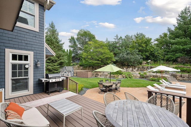 wooden terrace with a yard and a grill