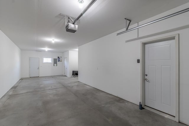 garage featuring electric panel and a garage door opener