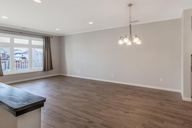 unfurnished living room with dark hardwood / wood-style floors, ornamental molding, and an inviting chandelier