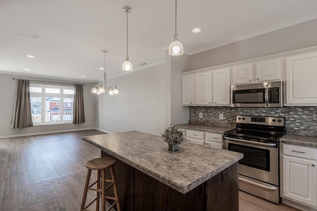 kitchen featuring backsplash, white cabinetry, and stainless steel appliances