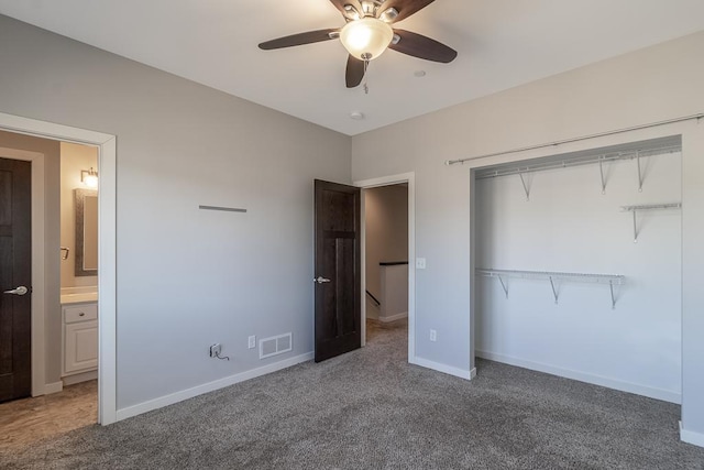 unfurnished bedroom with carpet, ceiling fan, connected bathroom, and a closet