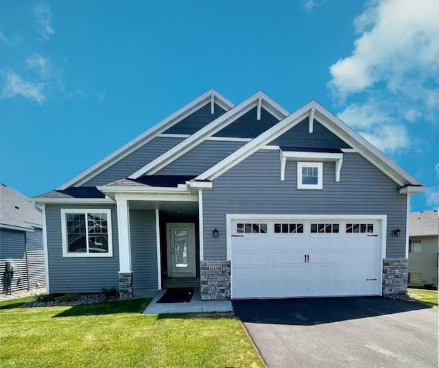 craftsman inspired home with a front yard and a garage