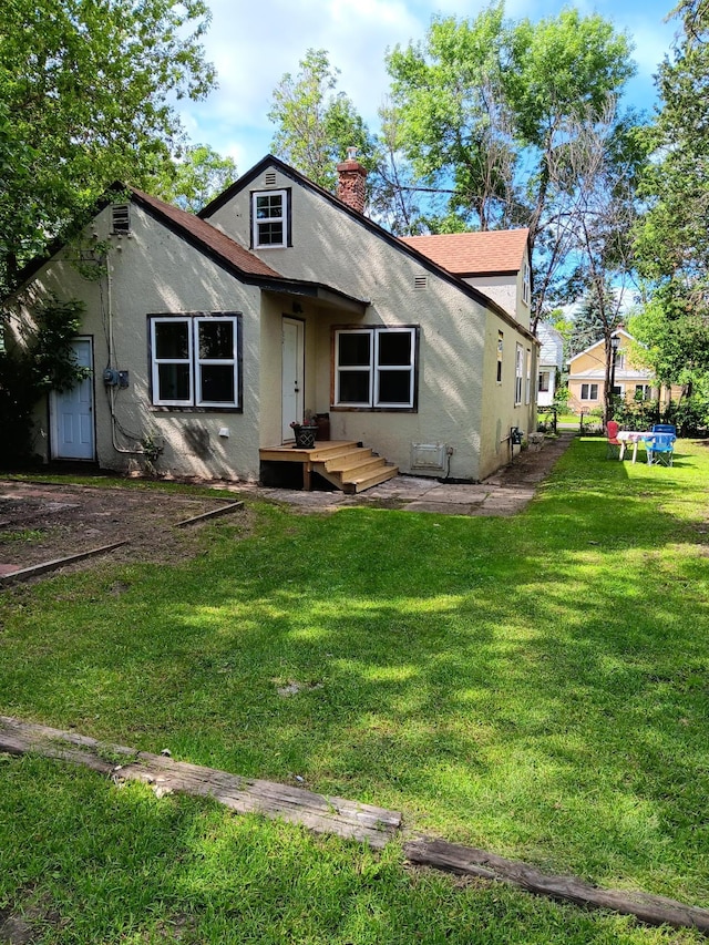 bungalow-style home with a front lawn