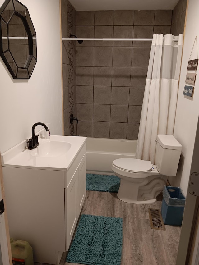 full bathroom featuring shower / bathtub combination with curtain, vanity, hardwood / wood-style flooring, and toilet