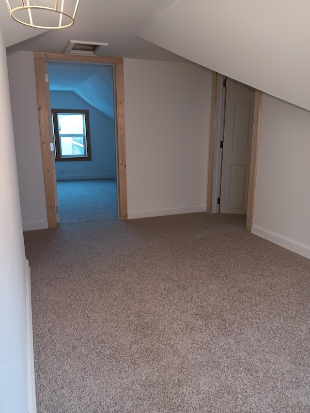 interior space featuring lofted ceiling and carpet floors