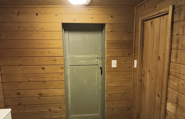 entryway featuring wooden walls