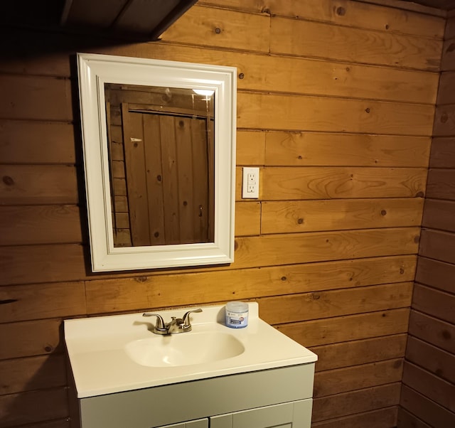 bathroom with vanity and wooden walls