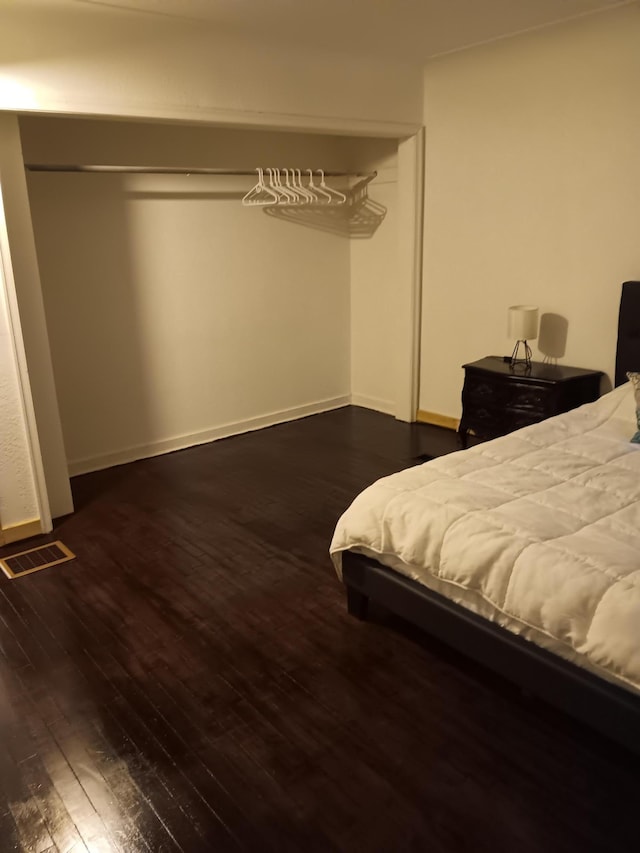 unfurnished bedroom with dark hardwood / wood-style flooring