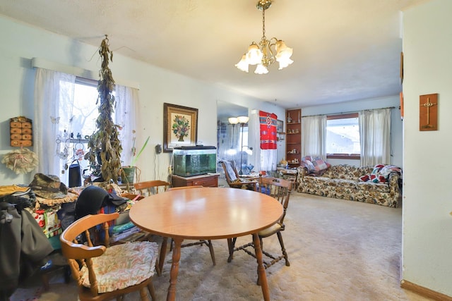 dining area with carpet and an inviting chandelier