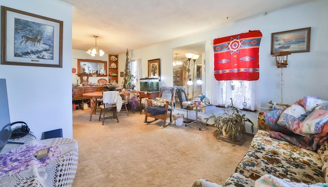 carpeted living room featuring an inviting chandelier