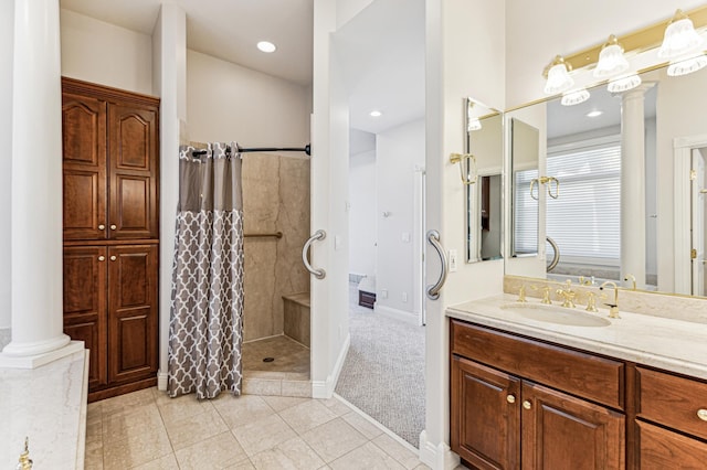 bathroom featuring decorative columns, vanity, tile patterned floors, and a shower with curtain