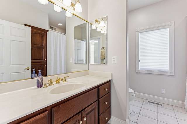 bathroom featuring vanity, tile patterned floors, and toilet