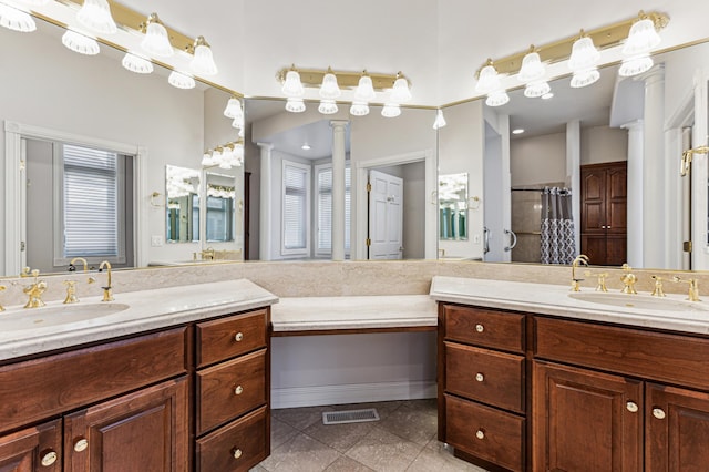 bathroom with vanity, tile patterned flooring, decorative columns, and plenty of natural light