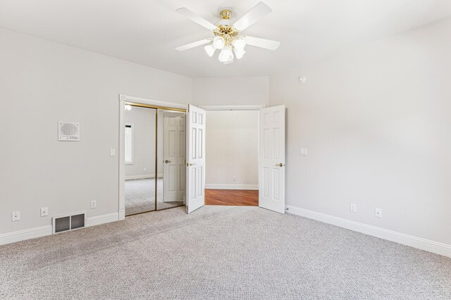 unfurnished bedroom with carpet floors, a closet, and ceiling fan