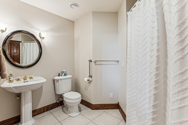 bathroom with tile patterned floors and toilet