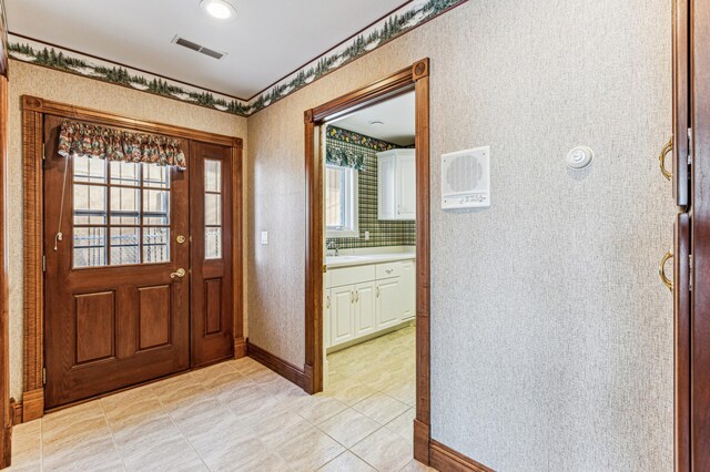 foyer entrance with a healthy amount of sunlight and sink