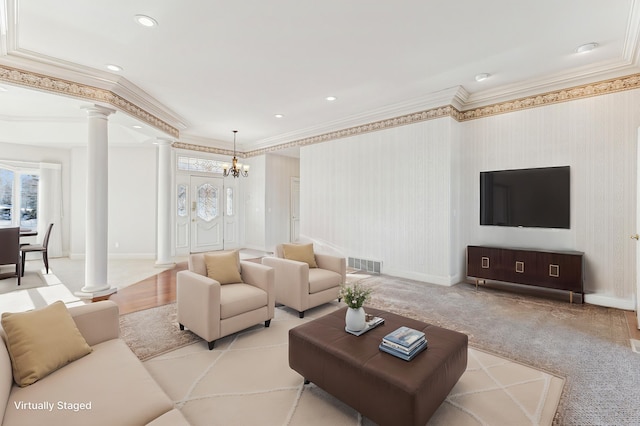 living area featuring ornamental molding, visible vents, decorative columns, and baseboards