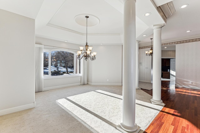 unfurnished dining area with decorative columns, baseboards, a tray ceiling, and recessed lighting