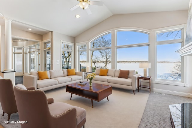 living room featuring visible vents, a ceiling fan, light colored carpet, vaulted ceiling, and ornate columns