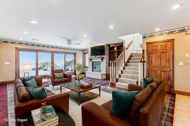 living area with recessed lighting, stairway, a fireplace, and baseboards