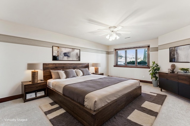 bedroom featuring light colored carpet, ceiling fan, and baseboards